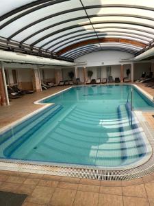 a large swimming pool in a building at Joy Apartman in Zalakaros