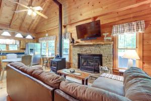 a living room with a couch and a fireplace at Ellijay Cabin with Deck and Hot Tub! in Ellijay