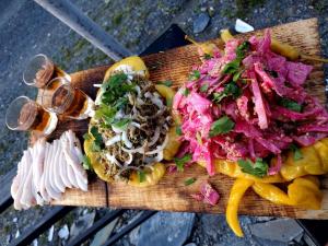 a wooden cutting board topped with different types of food at Hotel Dauber in Lalkhori