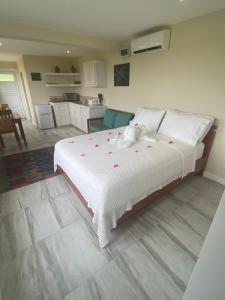 a bedroom with a large bed with pink flowers on it at Memwa Villas in Castries