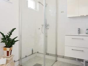 a shower with a glass door in a bathroom at Modern Beach Cottage in Tofta, Gotland in Gnisvärd