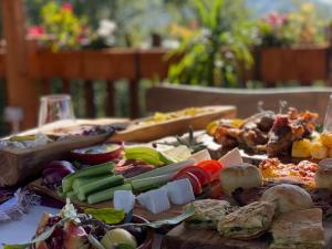 a table topped with lots of different types of food at Natyra e Qetë Hideaway in Lezhë
