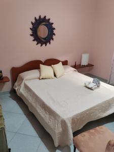 a bedroom with a bed with a mirror on the wall at Villa Dea in Trabia