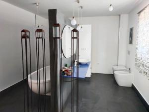 a bathroom with two sinks a tub and two toilets at Preciosa casa grande con patio en Sevilla 8PAX in Seville
