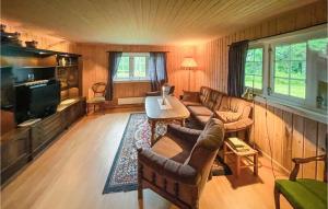 a living room with a couch and a tv at Nice Home In Sagstua With Lake View 