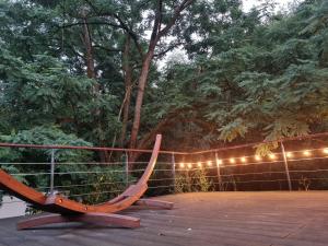 a wooden bench sitting on a deck with lights at Klimaanlage, 5 Sterne Bahnhoftraum, Appartement "Waldliebe" 133qm, große Terrasse 70qm, QR Code scannen für virtuellen Rundgang, Premium Ausstattung in Braunfels +37 photos