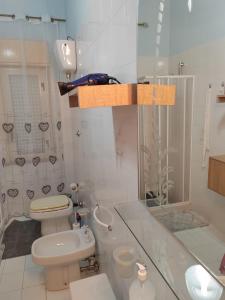 a white bathroom with a toilet and a shower at Villa Dea in Trabia