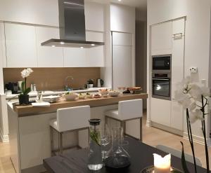 a kitchen with white cabinets and a table with chairs at Albrecht108 in Berlin