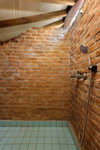 uma casa de banho em tijolo com um chuveiro numa parede de tijolos em Chakra Beach Kabak em Faralya