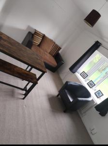 a living room with a bench and a chair at Flat sleeps 5 people in Guisborough in Guisborough