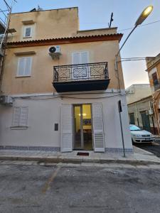 a white building with a balcony on top of it at Lu Màri case vacanze in Balestrate