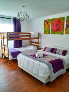 a bedroom with two bunk beds and a chandelier at Hotel Bianca Boutique in Viña del Mar