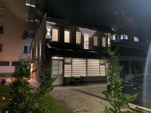 a house with white shutters on a building at night at Guest House Stojanoski in Ohrid