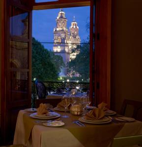 a dining table with a view of a building at Casa Grande Hotel Boutique in Morelia +63 photos