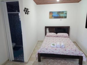 a bedroom with a bed with shoes on it at Cantinho da Saudade in Campos do Jordão