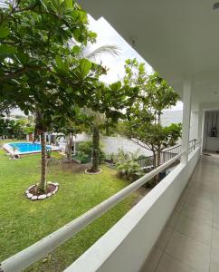 einen Balkon eines Hauses mit Bäumen und einem Pool in der Unterkunft Casa Grace in Emiliano Zapata