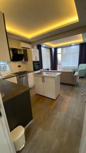 a large kitchen with white cabinets and a counter top at BORDO SUİTE HOTEL in Trabzon