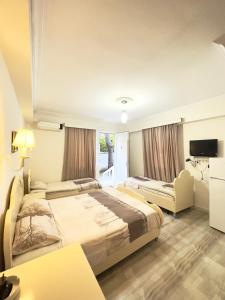 a hotel room with two beds and a television at Tbiliselebi Hotel Ureki in Ureki +17 photos