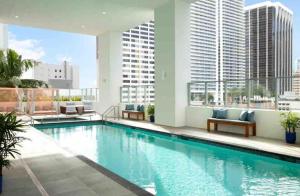 a swimming pool on the roof of a building at Miami Downtown Comfy Condo-Hotels in a luxury modern building in Miami