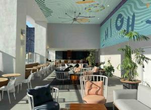 a lobby with chairs and tables and a clock on the ceiling at Miami Downtown Comfy Condo-Hotels in a luxury modern building in Miami