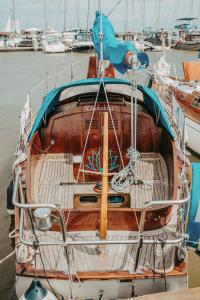 a boat is docked in a harbor with other boats at Jachta " Džaladūta" in Nida