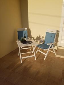 two chairs and a table with a bottle of wine at Apartmani KaLu in Mlini +19 photos