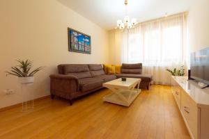 a living room with a couch and a table at Urban Suite Zlatibor in Zlatibor