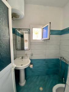 a bathroom with a sink and a mirror at Ksamil Guest House Dea in Ksamil +15 photos
