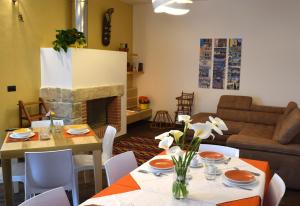 a living room with a table and a fireplace at Culummi Bed & Breakfast in Cavallino di Lecce