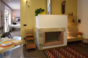a living room with a fireplace and a dining table at Culummi Bed & Breakfast in Cavallino di Lecce