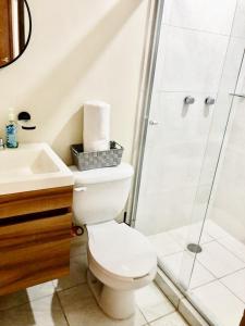 a bathroom with a toilet and a shower at Casa Familiar Chocolate - Olímpica - 5 Min del Malecón in Mazatlán +8 photos