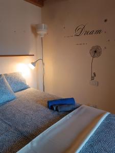 a bedroom with a bed with a lamp and a flower on the wall at Casa Garibaldi in Lucca