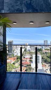 a large window in a building with a view of a city at Departamento 2 ambientes full amenities + Cochera in Santa Cruz de la Sierra