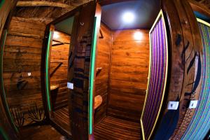 a wooden elevator in a room with a mirror at Kin Hostal and Camping in Holbox Island