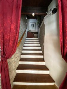 a stairway with a red curtain and a stair case at San Marino Skyline - Suite Virgilio in San Marino