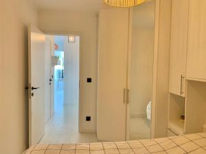 a bedroom with a door leading to a hallway at BEACH apartment met directe toegang tot het STRAND ! in Knokke-Heist +43 photos