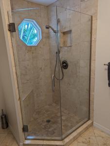 a shower with a glass door in a bathroom at Steps from the Gulf of Mexico II in Holmes Beach