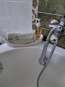 a bathroom sink with a roll of toilet paper on it at La casa di mezzo-affitti brevi-zona ospedali in Busso +16 photos