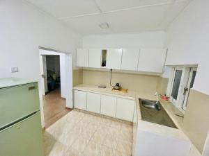 an empty kitchen with white cabinets and a sink at The Colombo Home in Nugegoda