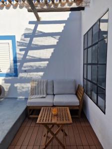 a couch and a table on a patio at Casa de Santa Margarida in Mourão