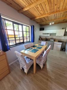 a kitchen with a table and chairs in a room at Domek murowany w Dolinie Symsarny in Lidzbark Warmiński