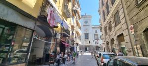 un grupo de personas caminando por una calle de la ciudad en Il Fondaco all'Archivio Storico en Nápoles