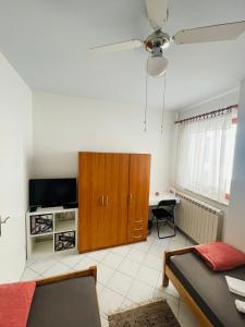 a living room with a bed and a cabinet and a table at House365 in Koper