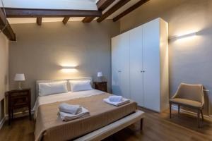een slaapkamer met een groot bed en een stoel bij (Sferisterio) Casa Carmen con idromassaggio in Macerata
