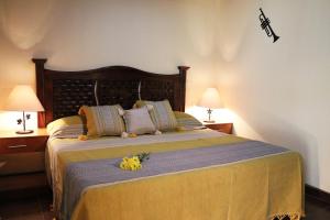 a bedroom with a large bed with flowers on it at Hotel Castillo Santa Cecilia in Tapalpa