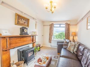 a living room with a couch and a fireplace at Pennine View in Long Marton