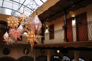 a building with chandaliers hanging from the ceiling at Hotel Castillo Santa Cecilia in Tapalpa