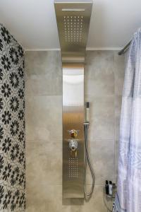 a bathroom with a shower with a shower head at Venus Studio in Stafylos