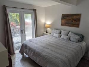 a bedroom with a large bed and a sliding glass door at Steps from the Gulf of Mexico II in Holmes Beach