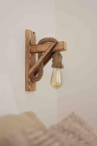a wooden cross with a light on a wall at Casa dos Islas Loft in San Antonio Bay